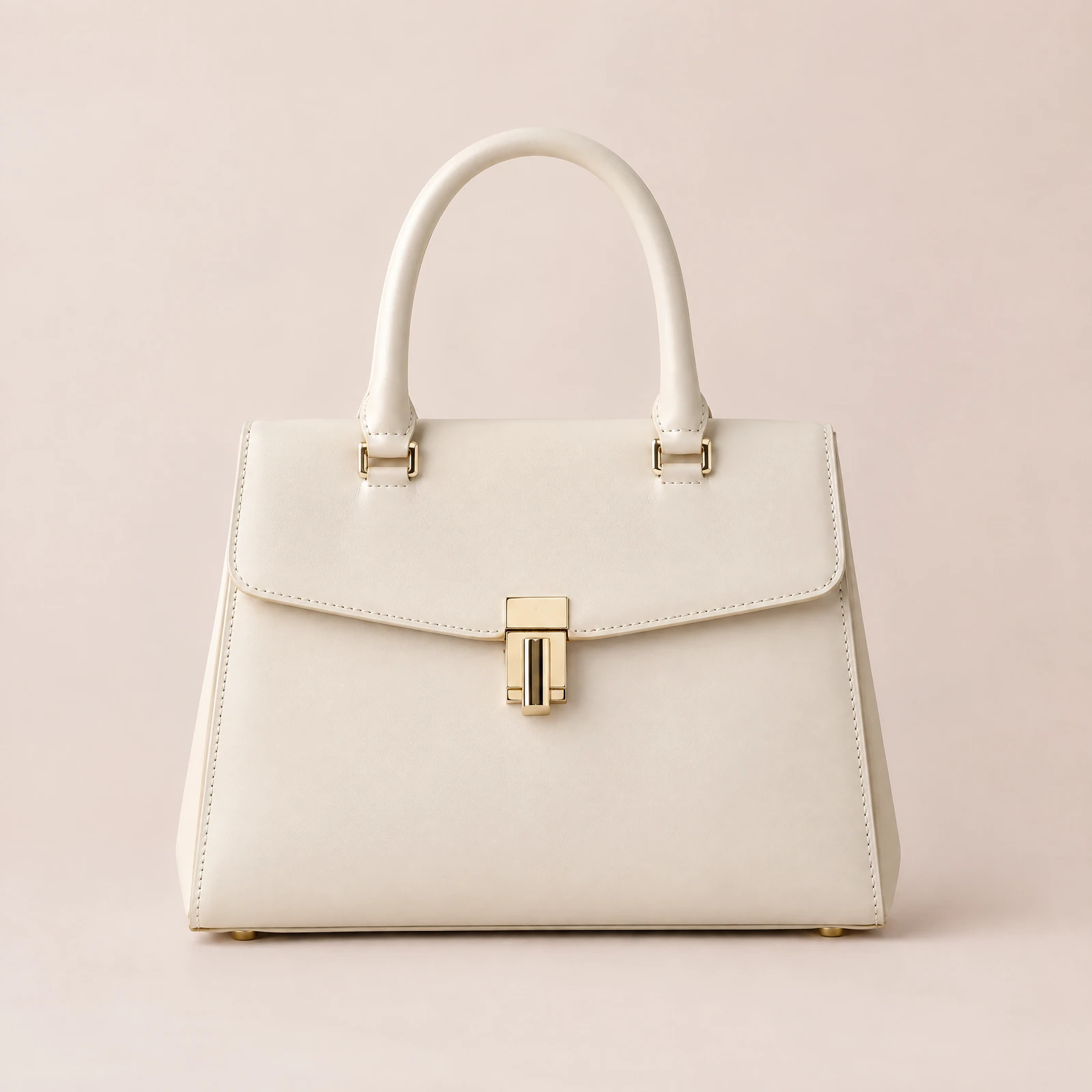 Ivory structured satchel with flap and top handle on a blush background