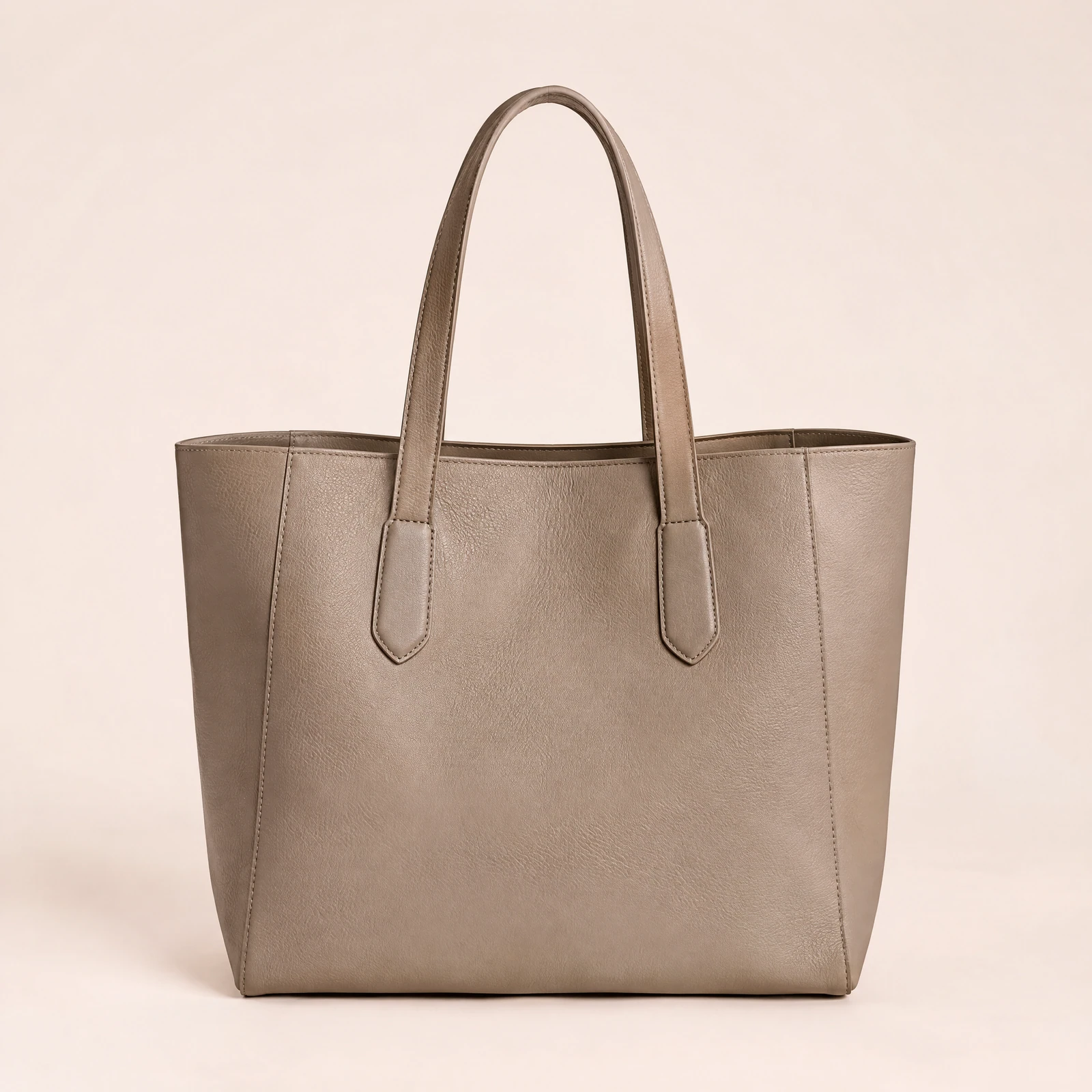 Taupe tote bag with two top handles on a blush background